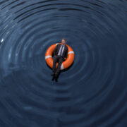 White business man floating on a life preserver