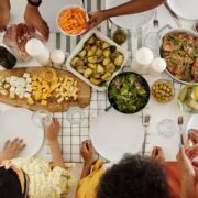 people around a table with food